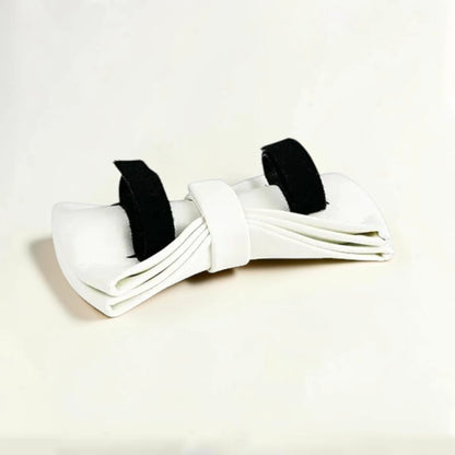White detachable dog bow tie on a beige background