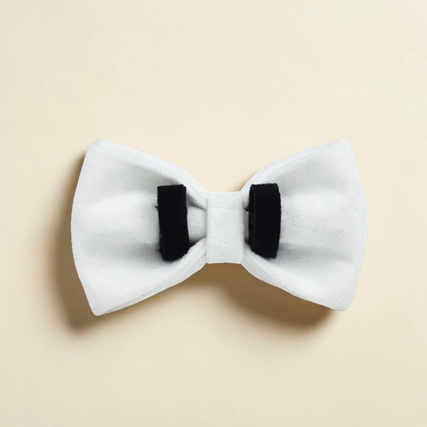 White dog detachable bow tie with black straps on a beige background